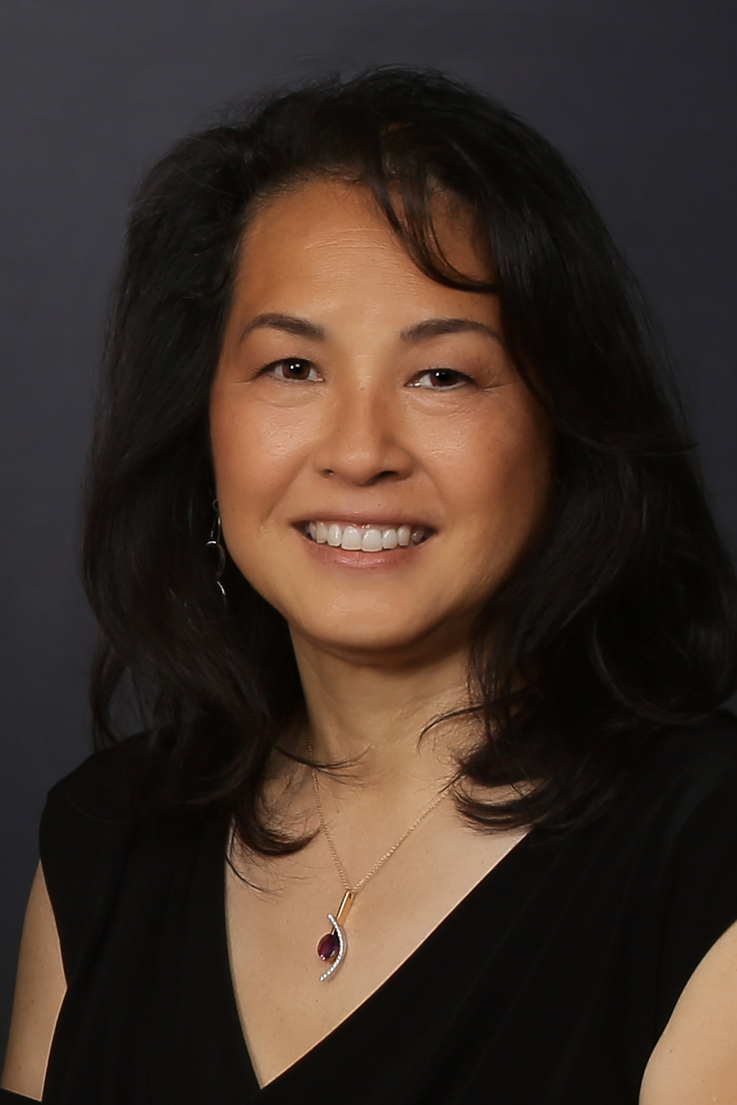 Photo of woman with dark hair and smiling on front - Laura Matsunaga